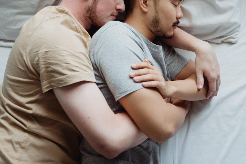 Free Two Men Cuddling in Bed Stock Photo