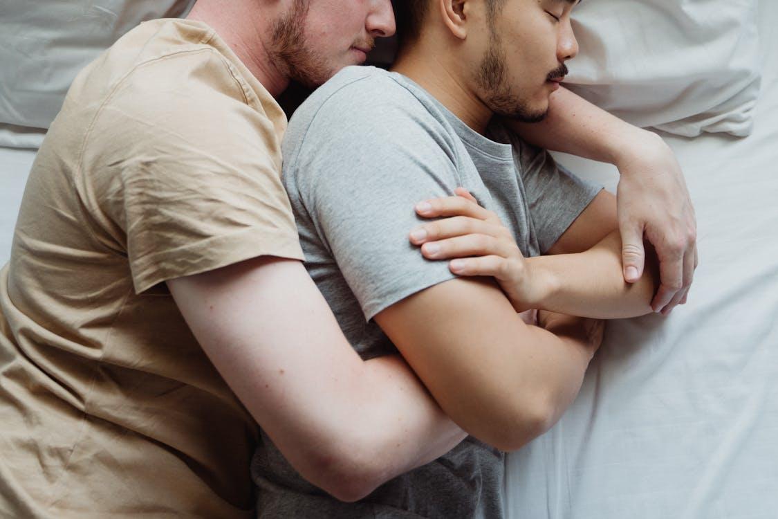 Free Two Men Cuddling in Bed Stock Photo